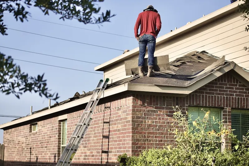 Professional roofer working on a residential roof in Shafer